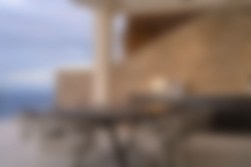 The sheltered, shaded al fresco dining area is served by a barbecue.